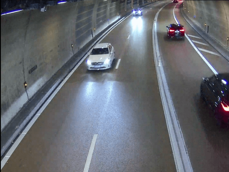 Camera view of a road tunnel with vehicles in traffic
