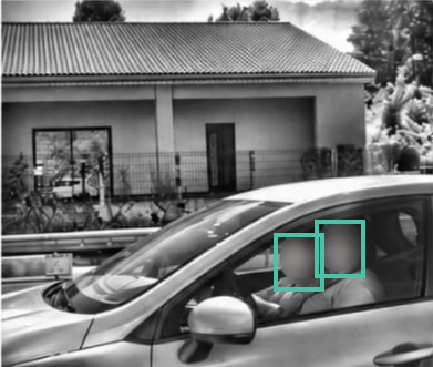 Side view of a vehicle with occupant faces blurred and framed by AI detection